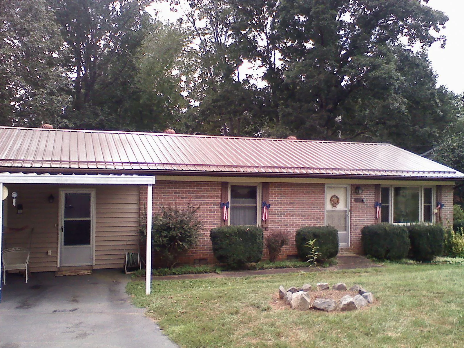 Bronze metal roof and carport on a brick ranch home — Roof Repair work by our crew in Fillmore